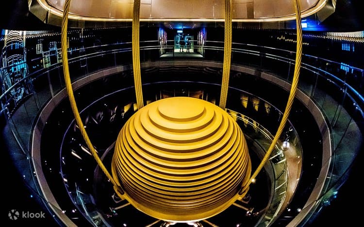 The 660-ton golden tuned mass damper ball suspended inside Taipei 101, visible from the observation deck