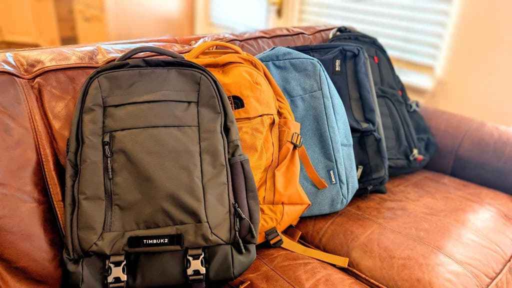 A row of backpacks showing different sizes, materials, straps, zippers, and pocket layouts